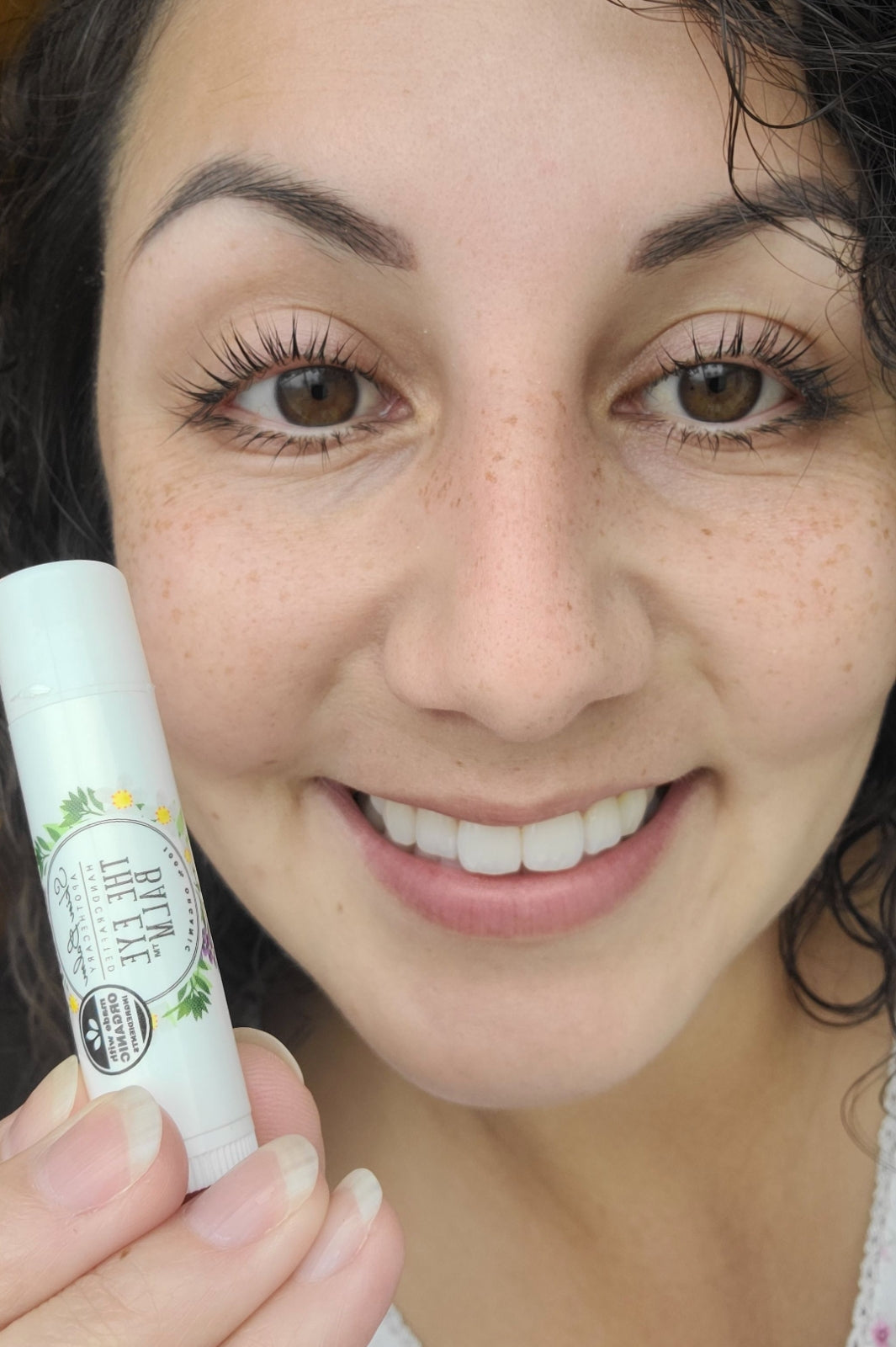 A testimonial photo from a real customer using The Eye Balm™.